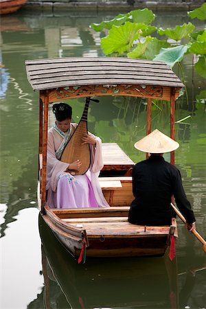 suzhou - A woman playing pipa on a boat at the garden to Liuyuan, Suzhou, Jiangsu Province, China Stock Photo - Rights-Managed, Code: 855-05982307