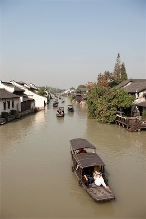 Tourist boats on canal at old town of Wuzhen, Zhejiang, China Stock Photo - Rights-Managed, Code: 855-05982739