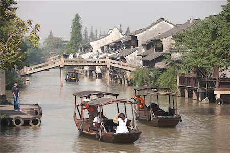 Tourist boats on canal at old town of Wuzhen, Zhejiang, China Stock Photo - Rights-Managed, Code: 855-05982741