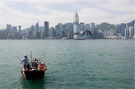 Hong Kong skyline with a fishing boat in the harbour,Hong Kong Stock Photo - Rights-Managed, Code: 855-03024449