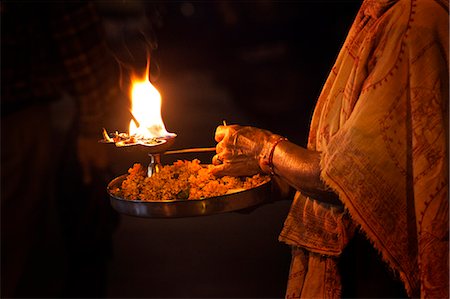 rivers of india - Priest holding a burning oil lamp in puja thaali during evening prayer (Aarti) at Har Ki Pauri, River Ganges, Haridwar, Uttarakhand, India Stock Photo - Rights-Managed, Code: 857-06721488