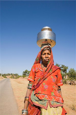 Woman carrying brass pot on her head, Kumbhalgarh, Udaipur, Rajasthan, India Stock Photo - Rights-Managed, Code: 857-03192513