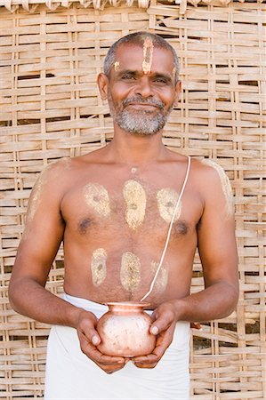 Portrait of a man holding a kalash, Hampi, Karnataka, India Stock Photo - Rights-Managed, Code: 857-03192810