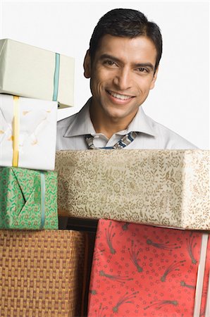 Businessman holding gift boxes Stock Photo - Rights-Managed, Code: 857-03554047