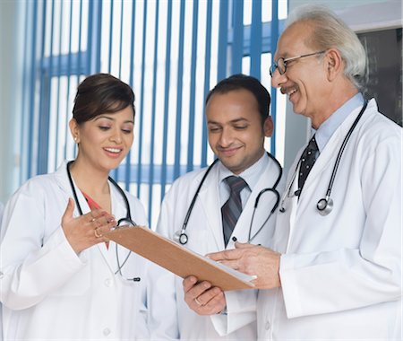 Doctors discussing a report, Gurgaon, Haryana, India Stock Photo - Rights-Managed, Code: 857-03554218