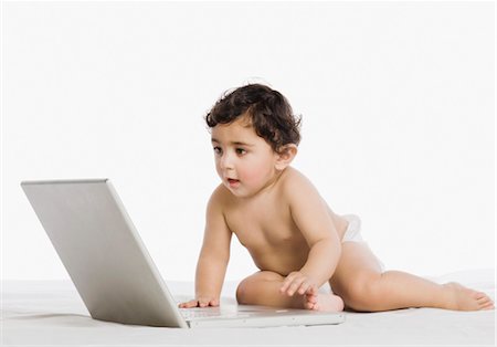 Baby boy playing with a laptop Stock Photo - Rights-Managed, Code: 857-03554310