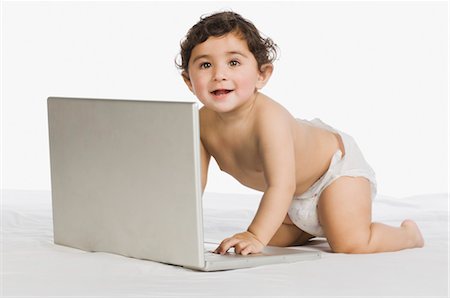 Baby boy playing with a laptop Stock Photo - Rights-Managed, Code: 857-03554312