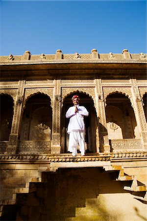 security costume - Mid adult man standing in front of a temple, Jaisalmer Fort, Jaisalmer, Rajasthan, India Stock Photo - Rights-Managed, Code: 857-03553580