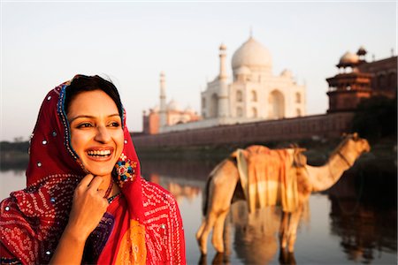 Woman smiling with mausoleum in the background, Taj Mahal, Agra, Uttar Pradesh, India Stock Photo - Rights-Managed, Code: 857-03553678