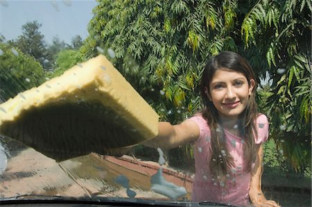 Woman washing a car and smiling, New Delhi, India Stock Photo - Rights-Managed, Code: 857-03553769