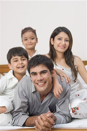 Family smiling on the bed Stock Photo - Rights-Managed, Code: 857-03553784