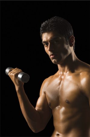 Man exercising with a dumbbell Stock Photo - Rights-Managed, Code: 857-03553901