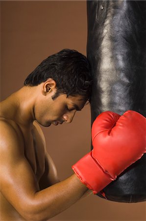 simsearch:400-03984387,k - Boxer with his head leaning on a punching bag Stock Photo - Rights-Managed, Code: 857-03553924