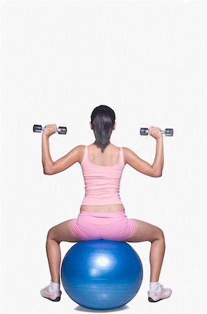 Young woman exercising on a fitness ball Stock Photo - Rights-Managed, Code: 857-03553964