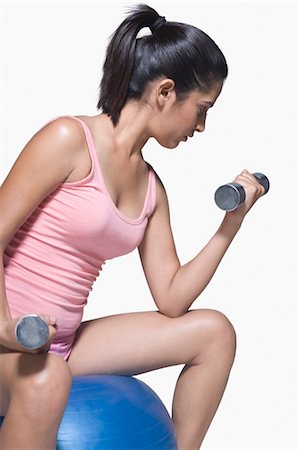 Young woman exercising on a fitness ball Stock Photo - Rights-Managed, Code: 857-03553968