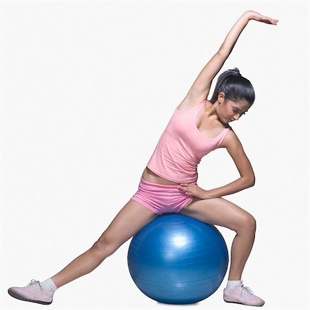Young woman exercising on a fitness ball Stock Photo - Rights-Managed, Code: 857-03553961