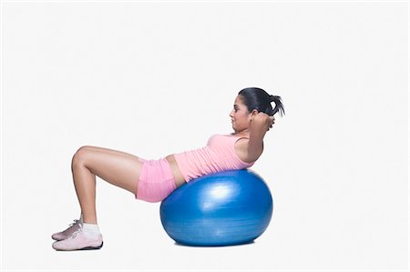 Young woman exercising on a fitness ball Stock Photo - Rights-Managed, Code: 857-03553963