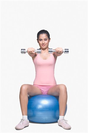 Young woman exercising on a fitness ball Stock Photo - Rights-Managed, Code: 857-03553972