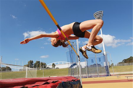 simsearch:858-05604961,k - Jeune athlète féminine effectuant le saut en hauteur Photographie de stock - Rights-Managed, Code: 858-05604672