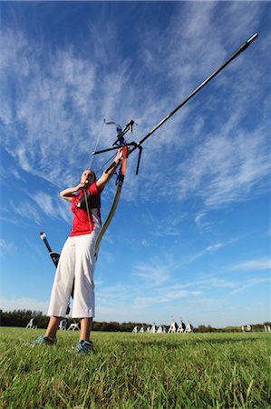 Young Female Archer Aiming at Target Stock Photo - Rights-Managed, Code: 858-05604827