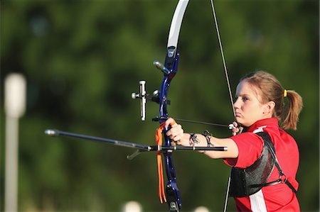 Young Female Archer Aiming at Target Stock Photo - Rights-Managed, Code: 858-05604887