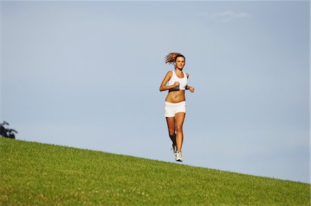 simsearch:633-01715682,k - Young Woman Jogging on Grass Stock Photo - Rights-Managed, Code: 858-05799358