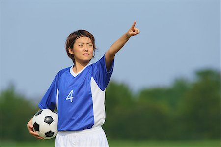soccer player holding ball - Woman Playing Soccer Photographie de stock - Rights-Managed, Code: 858-06617729