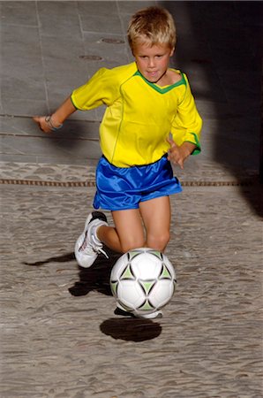 Young Boy Playing Soccer in the Street Stock Photo - Rights-Managed, Code: 858-03046603