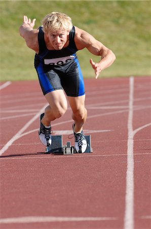 Sprinter Taking Off From Starting Blocks Stock Photo - Rights-Managed, Code: 858-03047390