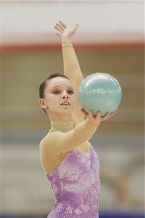 simsearch:858-03047740,k - Young woman performing rhythmic gymnastics balancing ball Stock Photo - Rights-Managed, Code: 858-03048934