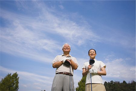 simsearch:858-03050428,k - Golfers smiling against cloudy sky Stock Photo - Rights-Managed, Code: 858-03049295