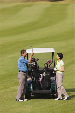 simsearch:858-03050428,k - Golfers taking putter from golf cart Stock Photo - Rights-Managed, Code: 858-03049296