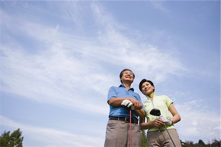 simsearch:858-03050428,k - Golfers smiling against cloudy sky Stock Photo - Rights-Managed, Code: 858-03049298