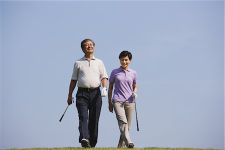 simsearch:858-03050428,k - Golfers walking together against blue sky Stock Photo - Rights-Managed, Code: 858-03049299