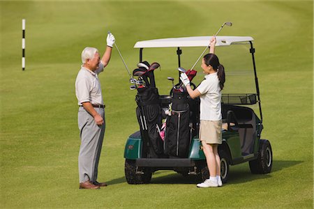 simsearch:858-03050428,k - Golfers taking putter from golf cart Stock Photo - Rights-Managed, Code: 858-03049293