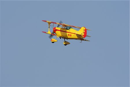 Biplane flying in blue sky Stock Photo - Rights-Managed, Code: 858-03049387