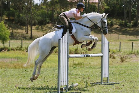 simsearch:858-03050485,k - Horse jumping by young female rider Stock Photo - Rights-Managed, Code: 858-03049399