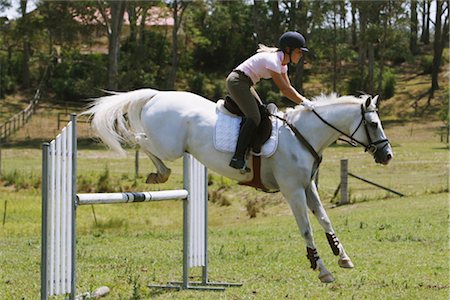 simsearch:858-03050485,k - Horse jumping by young female rider Stock Photo - Rights-Managed, Code: 858-03049400