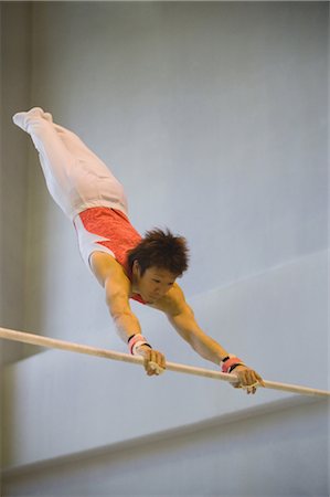simsearch:858-03799642,k - A male gymnast performing on horizontal bar Stock Photo - Rights-Managed, Code: 858-03050178