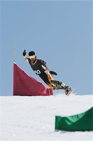 Snowboarder  Riding Snowboard on Snowfield Stock Photo - Rights-Managed, Code: 858-03448692