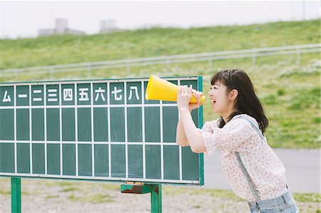Japanese girl holding a megaphone at a baseball court Stock Photo - Rights-Managed, Code: 859-06404842