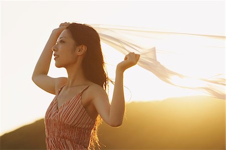 feel - Japanese woman holding a veil in the wind by the beach Stock Photo - Rights-Managed, Code: 859-06404893