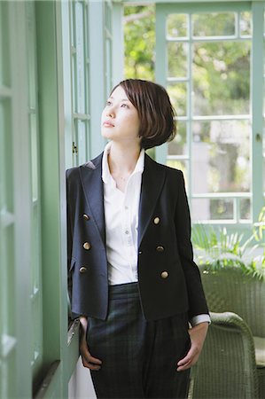 Femme japonaise dans un permanent veste noire de la fenêtre Photographie de stock - Rights-Managed, Code: 859-06404936