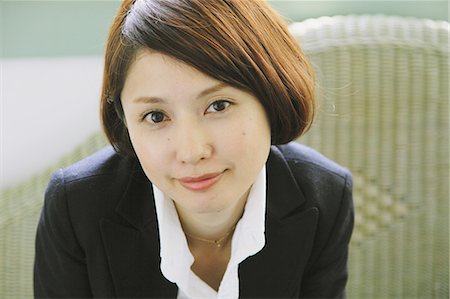single woman sitting on a chair home - Portrait of a Japanese woman in a black jacket looking at camera Stock Photo - Rights-Managed, Code: 859-06404943