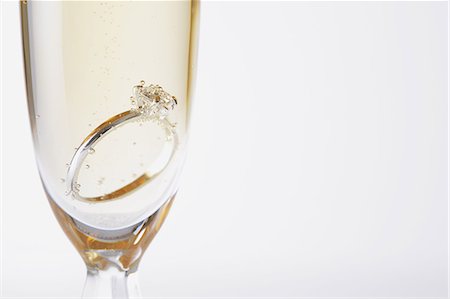 Glass of Champagne with a diamond ring in it Photographie de stock - Rights-Managed, Code: 859-06470031