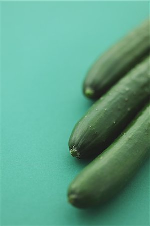 Three cucumbers on green background Stock Photo - Rights-Managed, Code: 859-06470043