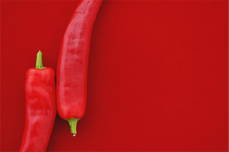 Chilli peppers on red background Stock Photo - Rights-Managed, Code: 859-06470051