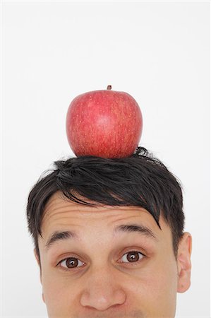 Businessman with an apple on the head Stock Photo - Rights-Managed, Code: 859-06537826