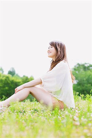 Smiling woman sitting in a park Stock Photo - Rights-Managed, Code: 859-06538062