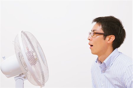 fan - Man Cooling Down With a Fan Stock Photo - Rights-Managed, Code: 859-06617405